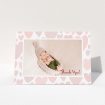 A baby card template titled "Pastel Hearts". It is an A6 card in a landscape orientation. It is a photographic baby card with room for 1 photo. "Pastel Hearts" is available as a folded card, with tones of pink and white.