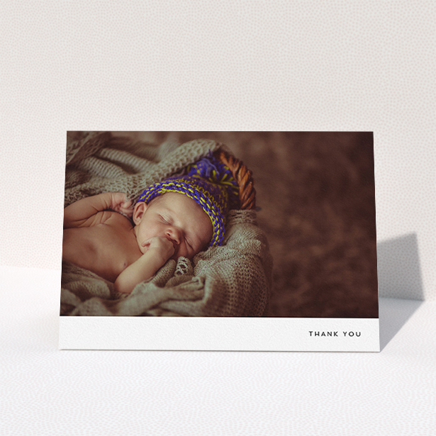 A baby card design titled "Thankful with Simplicity". It is an A5 card in a landscape orientation. It is a photographic baby card with room for 1 photo. "Thankful with Simplicity" is available as a folded card, with mainly white colouring.