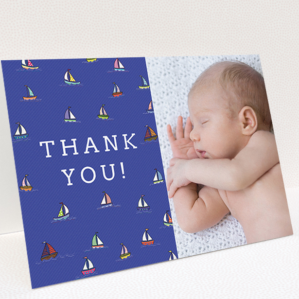 A baby thank you card template titled "Cowes Week". It is an A5 card in a landscape orientation. It is a photographic baby thank you card with room for 1 photo. "Cowes Week" is available as a folded card, with mainly blue colouring.