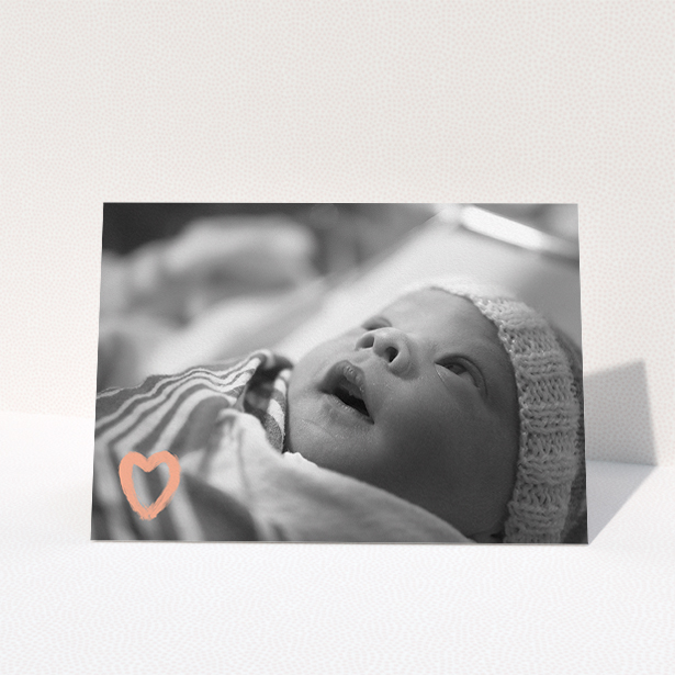 A baby thank you card design named "Hand Drawn Heart". It is an A5 card in a landscape orientation. It is a photographic baby thank you card with room for 1 photo. "Hand Drawn Heart" is available as a folded card, with mainly light pink colouring.