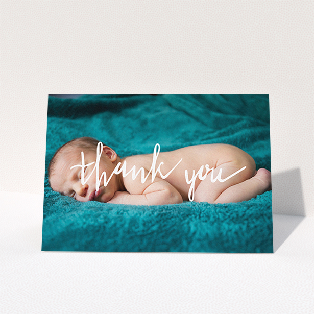 A baby thank you card design titled "Handwritten Thanks". It is an A6 card in a landscape orientation. It is a photographic baby thank you card with room for 1 photo. "Handwritten Thanks" is available as a folded card, with mainly white colouring.
