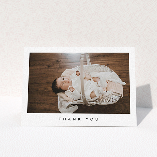 A baby thank you card design named "Simple". It is an A6 card in a landscape orientation. It is a photographic baby thank you card with room for 1 photo. "Simple" is available as a folded card, with mainly white colouring.