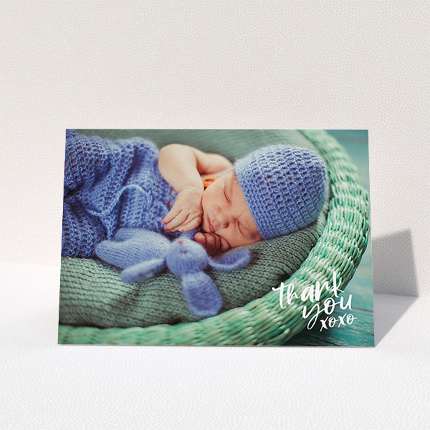 A baby thank you card design called "Thanks In the Corner". It is an A5 card in a landscape orientation. It is a photographic baby thank you card with room for 1 photo. "Thanks In the Corner" is available as a folded card, with mainly white colouring.