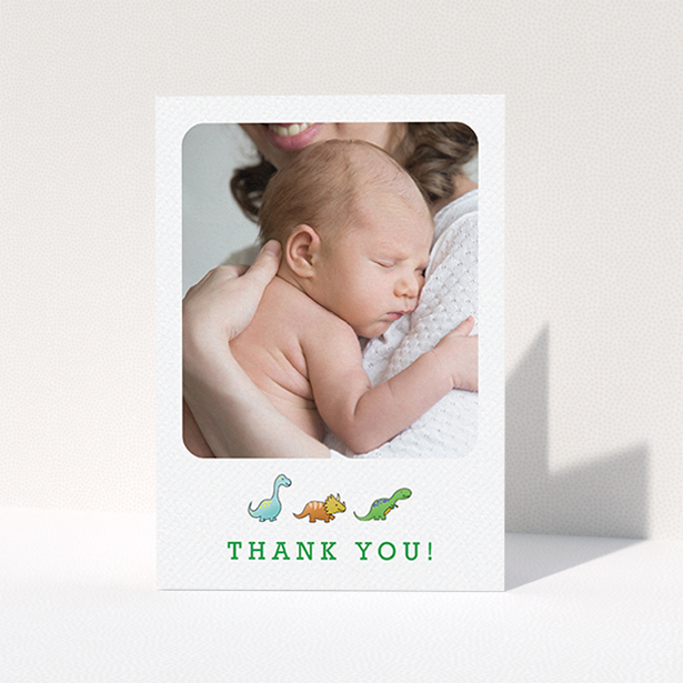 A baptism thank you card template titled "BabySaurus". It is an A6 card in a portrait orientation. It is a photographic baptism thank you card with room for 1 photo. "BabySaurus" is available as a folded card, with tones of white, green and light blue.