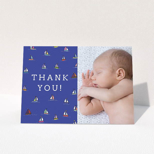 A baptism thank you card template titled "Cowes Week". It is an A5 card in a landscape orientation. It is a photographic baptism thank you card with room for 1 photo. "Cowes Week" is available as a folded card, with tones of blue, green and red.