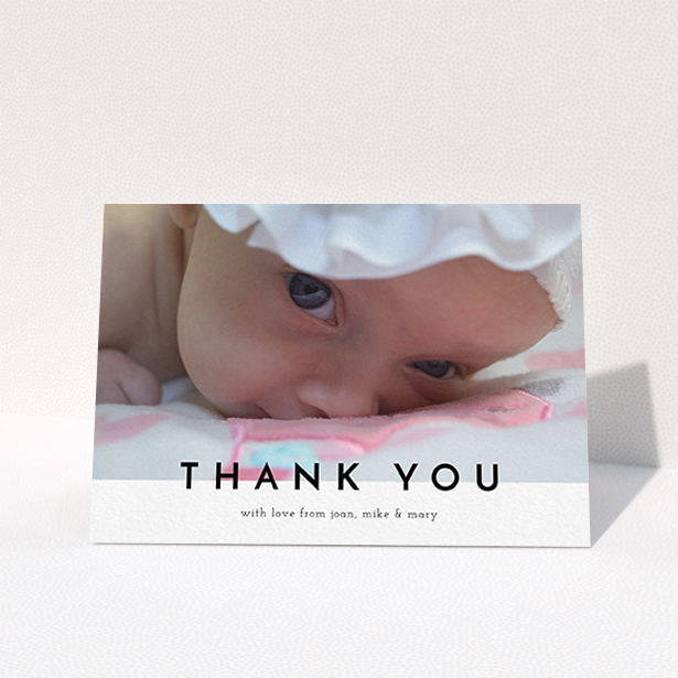 A baptism thank you card design titled "Cross Border". It is an A6 card in a landscape orientation. It is a photographic baptism thank you card with room for 1 photo. "Cross Border" is available as a folded card, with mainly white colouring.
