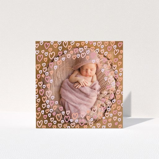 Baptism Thank You Card Design - "Pink Hearts" A baptism thank you card called "Pink Hearts". It is a square (148mm x 148mm) card in a square orientation. It is a photographic baptism thank you card with room for 1 photo. "Pink Hearts" is available as a folded card, with mainly pink colouring.