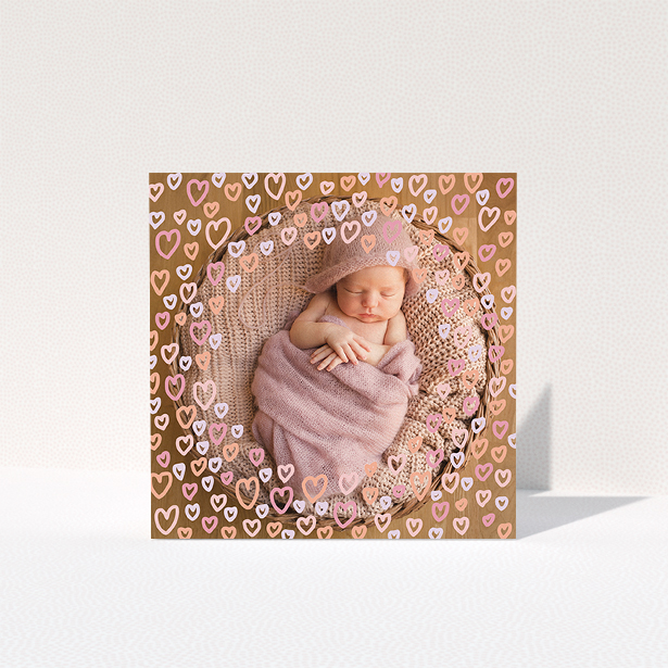 A baptism thank you card called "Pink Hearts". It is a square (148mm x 148mm) card in a square orientation. It is a photographic baptism thank you card with room for 1 photo. "Pink Hearts" is available as a folded card, with mainly pink colouring.
