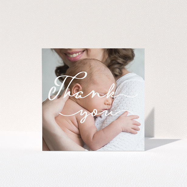 A baptism thank you card named "White Thank You". It is a square (148mm x 148mm) card in a square orientation. It is a photographic baptism thank you card with room for 1 photo. "White Thank You" is available as a folded card, with mainly white colouring.