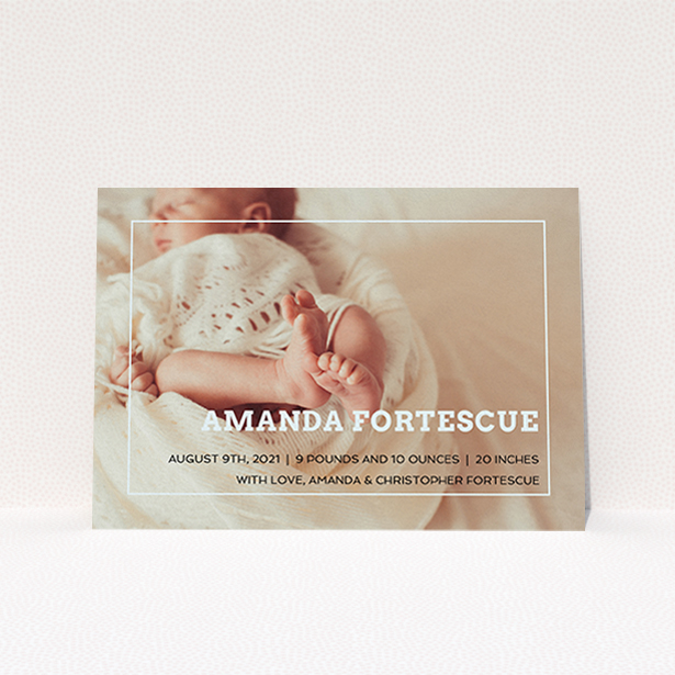 A birth announcement card called "Over Photo Frame". It is an A6 card in a landscape orientation. It is a photographic birth announcement card with room for 1 photo. "Over Photo Frame" is available as a flat card, with mainly light blue colouring.