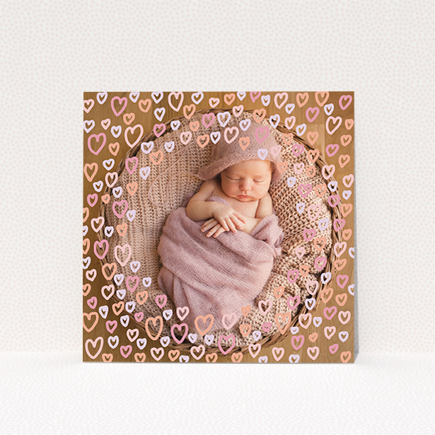 A christening invite design called "Pink Hearts". It is a square (148mm x 148mm) invite in a square orientation. It is a photographic christening invite with room for 1 photo. "Pink Hearts" is available as a flat invite, with mainly pink colouring.