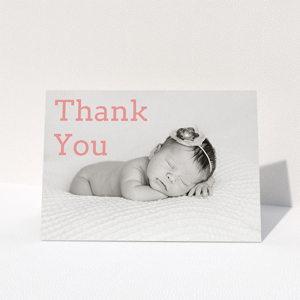 A christening thank you card design called "Big Thanks". It is an A5 card in a landscape orientation. It is a photographic christening thank you card with room for 1 photo. "Big Thanks" is available as a folded card, with mainly light pink colouring.
