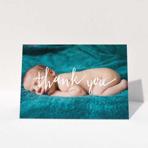 Christening Thank You Card Design - "Handwritten Thanks" A christening thank you card design called "Handwritten Thanks". It is an A6 card in a landscape orientation. It is a photographic christening thank you card with room for 1 photo. "Handwritten Thanks" is available as a folded card, with mainly white colouring.
