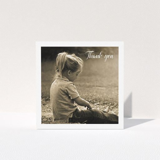 Communion Thank You Card Design - "Centralised Frame" A communion thank you card design named "Centralised Frame". It is a square (148mm x 148mm) card in a square orientation. It is a photographic communion thank you card with room for 1 photo. "Centralised Frame" is available as a folded card, with mainly white colouring.