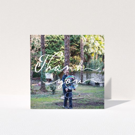 Communion Thank You Card Design - "Thin Handwriting" A communion thank you card design called "Thin Handwriting". It is a square (148mm x 148mm) card in a square orientation. It is a photographic communion thank you card with room for 1 photo. "Thin Handwriting" is available as a folded card, with mainly white colouring.