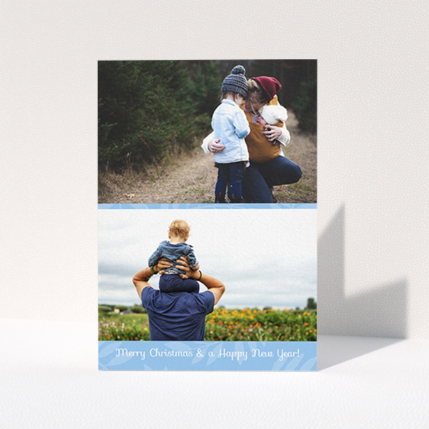 A custom christmas card design titled "Christmas Morning". It is an A6 card in a portrait orientation. It is a photographic custom christmas card with room for 2 photos. "Christmas Morning" is available as a folded card, with mainly blue colouring.