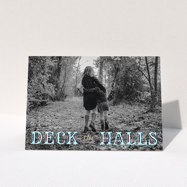 A custom christmas card named "Deck the Halls". It is an A5 card in a landscape orientation. It is a photographic custom christmas card with room for 1 photo. "Deck the Halls" is available as a folded card, with tones of blue and beige.