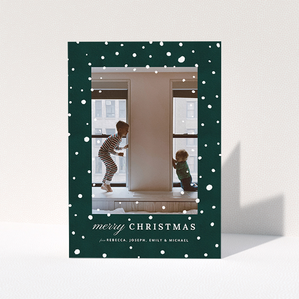 A custom christmas card called "Forrest Snow". It is an A5 card in a portrait orientation. It is a photographic custom christmas card with room for 1 photo. "Forrest Snow" is available as a folded card, with mainly green colouring.