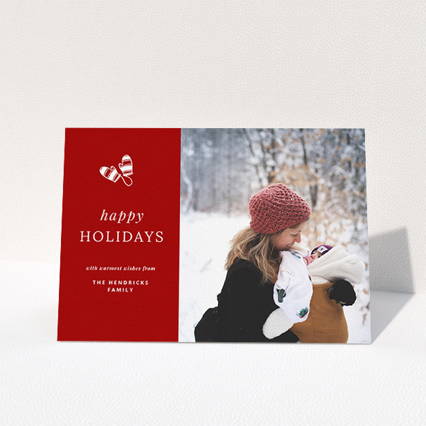 A custom christmas card design named "Warm Mittens". It is an A5 card in a landscape orientation. It is a photographic custom christmas card with room for 1 photo. "Warm Mittens" is available as a folded card, with tones of red and white.