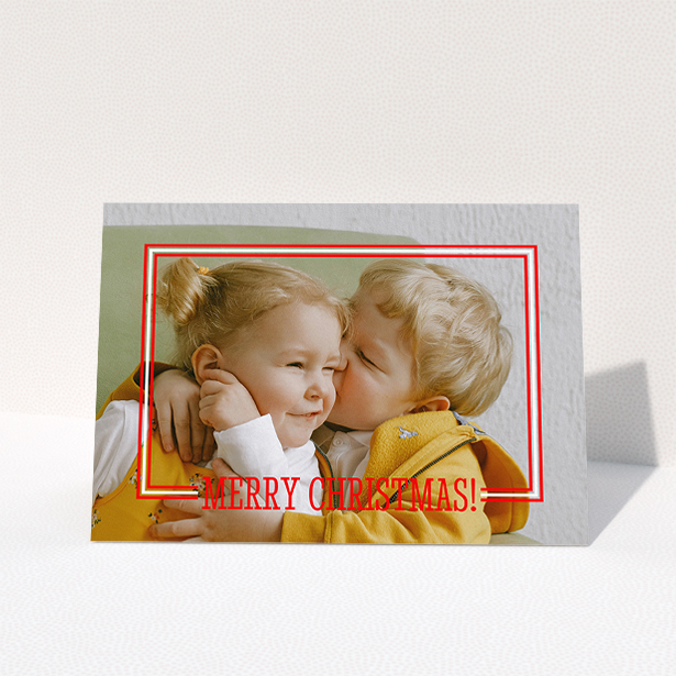 A family christmas card called "Christmas Border". It is an A5 card in a landscape orientation. It is a photographic family christmas card with room for 1 photo. "Christmas Border" is available as a folded card, with mainly red colouring.