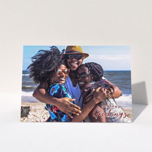 Family Christmas Card Design - "Christmas Stamp" A family christmas card named "Christmas Stamp". It is an A5 card in a landscape orientation. It is a photographic family christmas card with room for 1 photo. "Christmas Stamp" is available as a folded card, with mainly red colouring.