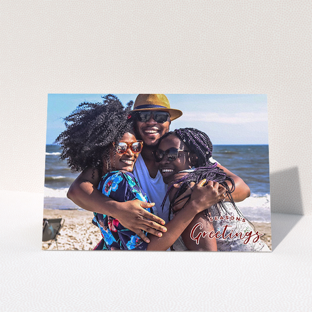 A family christmas card named "Christmas Stamp". It is an A5 card in a landscape orientation. It is a photographic family christmas card with room for 1 photo. "Christmas Stamp" is available as a folded card, with mainly red colouring.