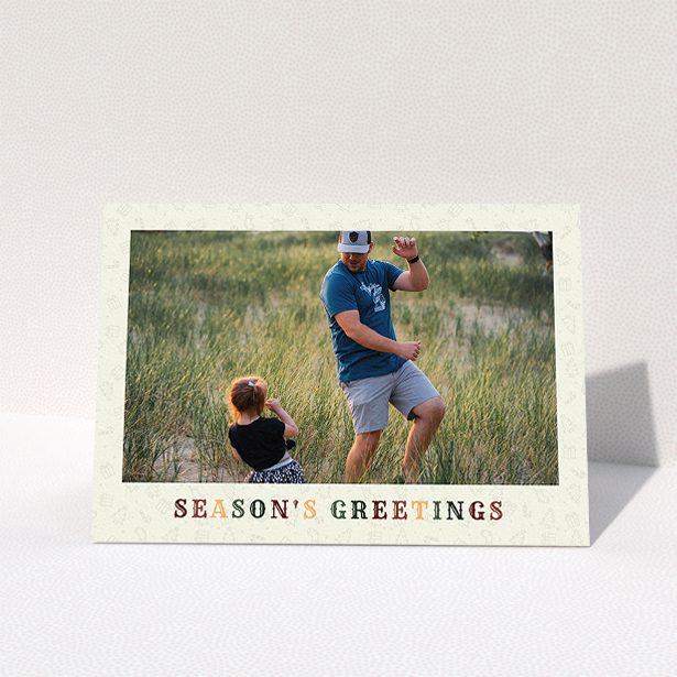 A family christmas card template titled "Dickensian". It is an A5 card in a landscape orientation. It is a photographic family christmas card with room for 1 photo. "Dickensian" is available as a folded card, with tones of cream, red and dark green.