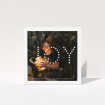 A family christmas card design titled "Joy". It is a square (148mm x 148mm) card in a square orientation. It is a photographic family christmas card with room for 1 photo. "Joy" is available as a folded card, with mainly white colouring.