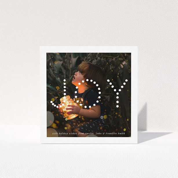 A family christmas card design titled "Joy". It is a square (148mm x 148mm) card in a square orientation. It is a photographic family christmas card with room for 1 photo. "Joy" is available as a folded card, with mainly white colouring.