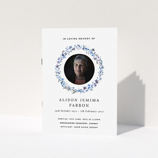 A funeral order of service named "Blue Floral. It is an A5 booklet in a portrait orientation. It is a photographic funeral program with room for 1 photo. "Blue Floral" is available as a folded booklet booklet, with tones of blue, light blue and purple.