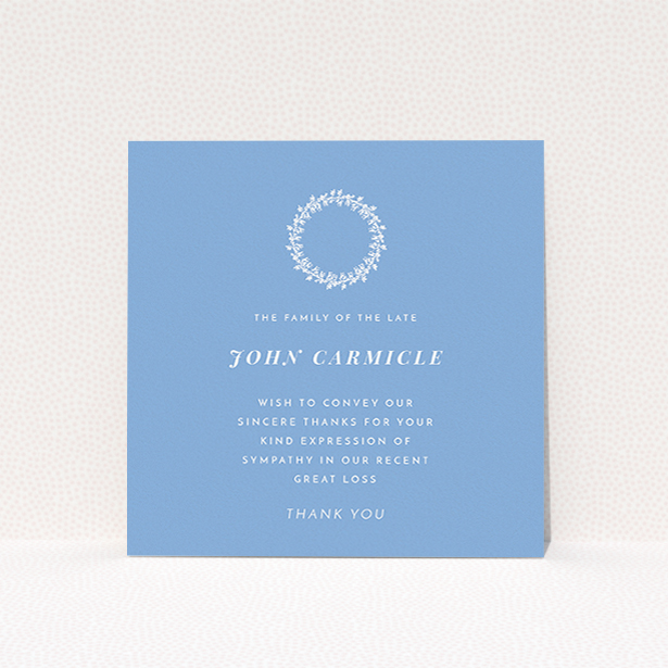 A funeral thank you card design named "White Wreath in Blue". It is a square (148mm x 148mm) card in a square orientation. "White Wreath in Blue" is available as a flat card, with tones of blue and white.