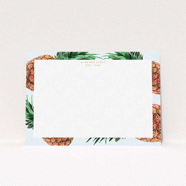 A ladies personalised note card design called "Falling pineapples". It is an A5 card in a landscape orientation. "Falling pineapples" is available as a flat card, with tones of light blue, green and brown.