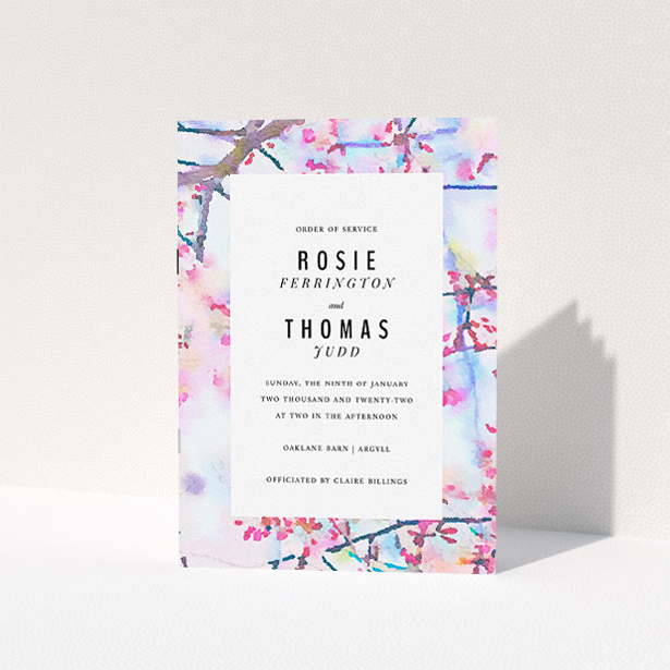 A multipage wedding order of service named "Pink Blossom Cover". It is an A5 booklet in a portrait orientation. "Pink Blossom Cover" is available as a folded booklet booklet, with tones of light blue, light pink and brown.