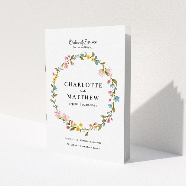 A multipage wedding order of service template titled "Spring Wedding Wreath". It is an A5 booklet in a portrait orientation. "Spring Wedding Wreath" is available as a folded booklet booklet, with mainly pink colouring.