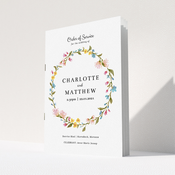 A multipage wedding order of service template titled "Spring Wedding Wreath". It is an A5 booklet in a portrait orientation. "Spring Wedding Wreath" is available as a folded booklet booklet, with mainly pink colouring.