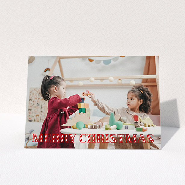 A personalised christmas card design titled "Candy Cane". It is an A6 card in a landscape orientation. It is a photographic personalised christmas card with room for 1 photo. "Candy Cane" is available as a folded card, with mainly red colouring.