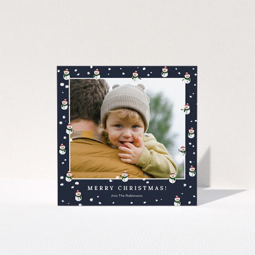 Personalised Christmas Card Design - "Snowmen and Snow" A personalised christmas card template titled "Snowmen and Snow". It is a square (148mm x 148mm) card in a square orientation. It is a photographic personalised christmas card with room for 1 photo. "Snowmen and Snow" is available as a folded card, with tones of navy blue, red and white.