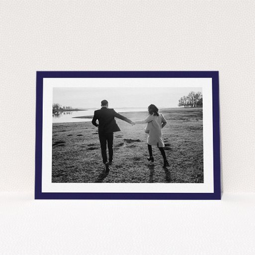Personalised Wedding Invitation Design - "Classic Navy Photo Frame" A personalised wedding invitation named "Classic Navy Photo Frame". It is an A5 invite in a landscape orientation. It is a photographic personalised wedding invitation with room for 1 photo. "Classic Navy Photo Frame" is available as a flat invite, with tones of blue and white.