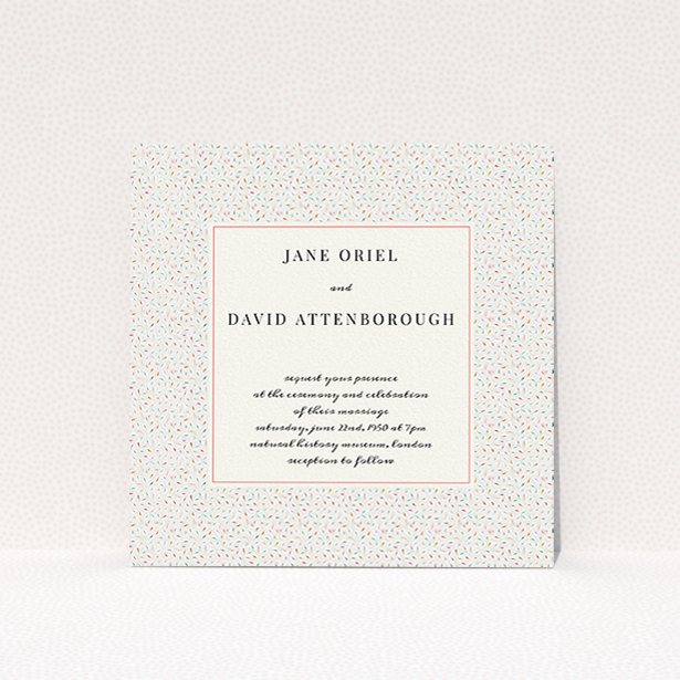 A personalised wedding invite named "A hint of confetti". It is a square (148mm x 148mm) invite in a square orientation. "A hint of confetti" is available as a flat invite, with tones of cream and red.