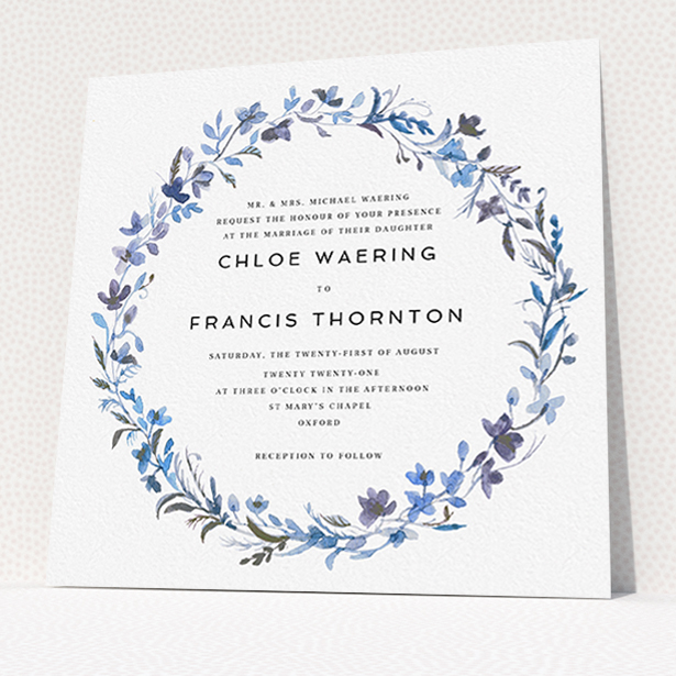 A personalised wedding invite design titled "Blue Floral Wreath". It is a square (148mm x 148mm) invite in a square orientation. "Blue Floral Wreath" is available as a flat invite, with tones of light blue, purple and grey.