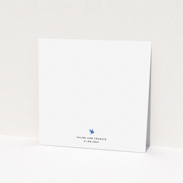 A personalised wedding invite design titled "Blue Floral Wreath". It is a square (148mm x 148mm) invite in a square orientation. "Blue Floral Wreath" is available as a flat invite, with tones of light blue, purple and grey.