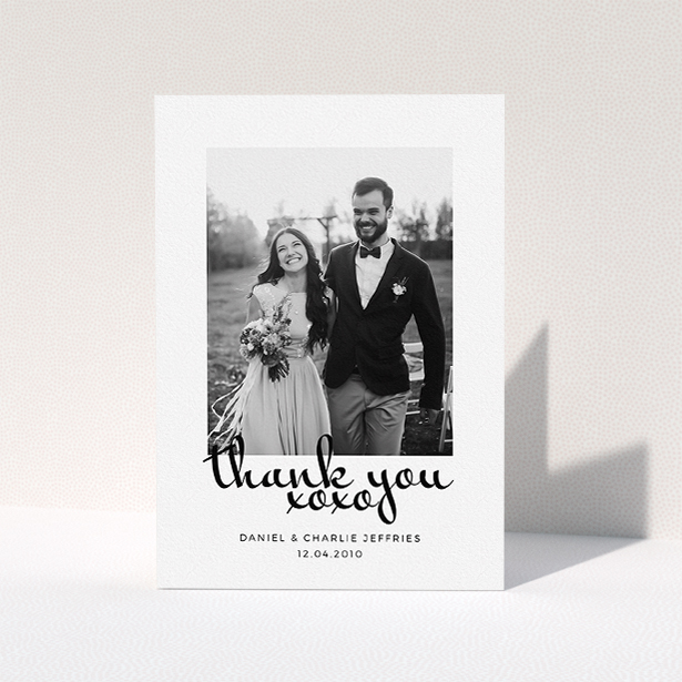 A photo wedding thank you card design named "XoXo". It is an A5 card in a portrait orientation. It is a photographic photo wedding thank you card with room for 1 photo. "XoXo" is available as a folded card, with mainly white colouring.