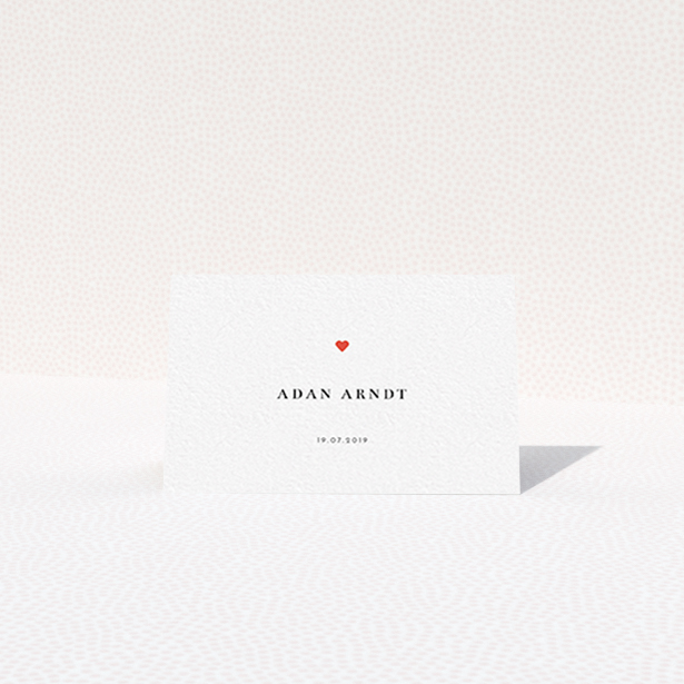 A place setting card design titled "A little heart". It is an 85 x 55mm card in a landscape orientation. "A little heart" is available as a folded card, with tones of white and red.