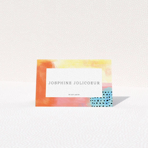 A place setting card template titled "Abstract Colours". It is an 85 x 55mm card in a landscape orientation. "Abstract Colours" is available as a folded card, with tones of orange, red and yellow.