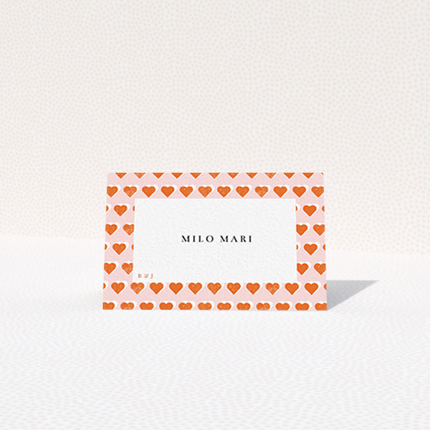 A place setting card design named "Rustic Hearts". It is an 85 x 55mm card in a landscape orientation. "Rustic Hearts" is available as a folded card, with tones of pink and orange.