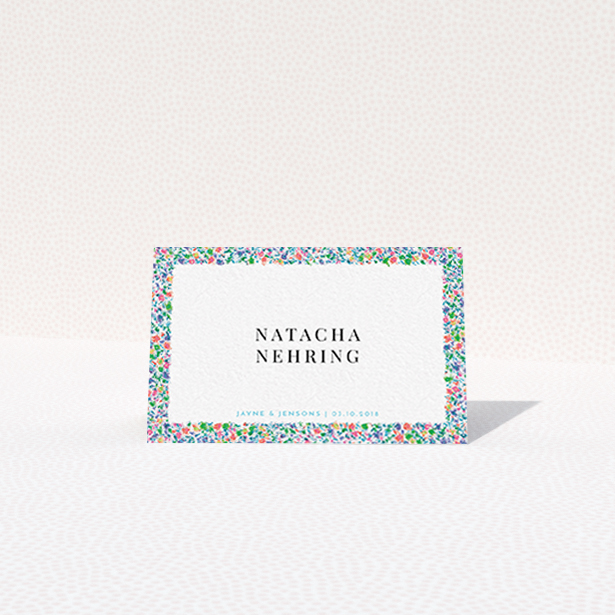 A place setting card design called "The faraway garden". It is an 85 x 55mm card in a landscape orientation. "The faraway garden" is available as a folded card, with tones of green, blue and red.