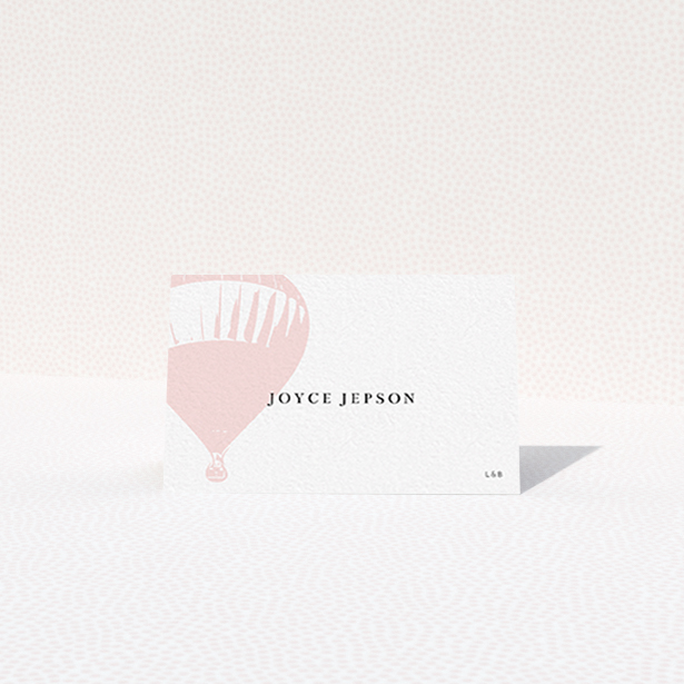 A table place card design named "Drifting Away". It is an 85 x 55mm card in a landscape orientation. "Drifting Away" is available as a folded card, with tones of pink and white.