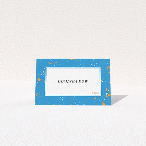 Table Place Card Design - "Orange Splatters" A table place card named "Orange Splatters". It is an 85 x 55mm card in a landscape orientation. "Orange Splatters" is available as a folded card, with tones of light blue and orange.