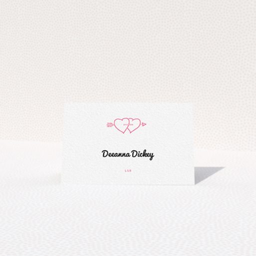 Table Place Card Design - "Shot to the Hearts" A table place card named "Shot to the Hearts". It is an 85 x 55mm card in a landscape orientation. "Shot to the Hearts" is available as a folded card, with tones of white and pink.