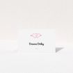 A table place card named "Shot to the Hearts". It is an 85 x 55mm card in a landscape orientation. "Shot to the Hearts" is available as a folded card, with tones of white and pink.